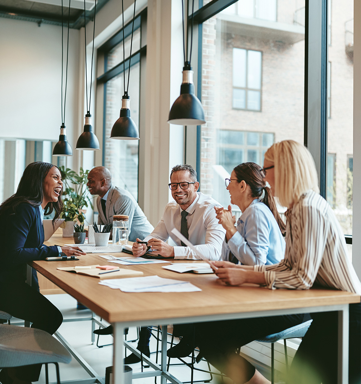 communities-image-bbh-meeting Smiling group of diverse business people meeting together in an office